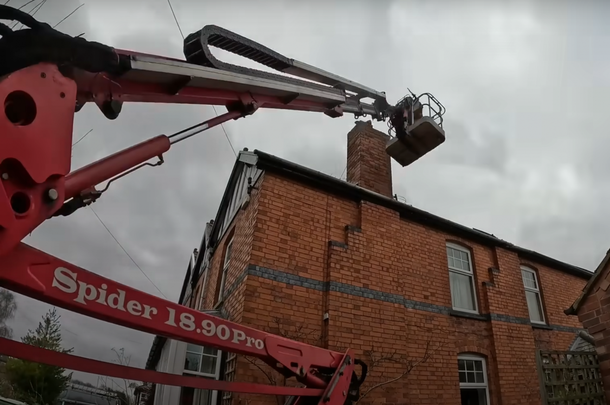 Chimney Removal In Farnfield, Nottinghamshire picture of cherrypicker next to a chimney being reduced in height in Farnsfield, Nottinghamshire