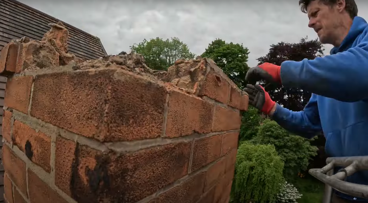 Removing a chimney in Wollerton, Nottingham Photo shows Danny Iwanejko AKA Dan the cherrypicker man, removing bricks from a chimney in Wollerton, Nottingham